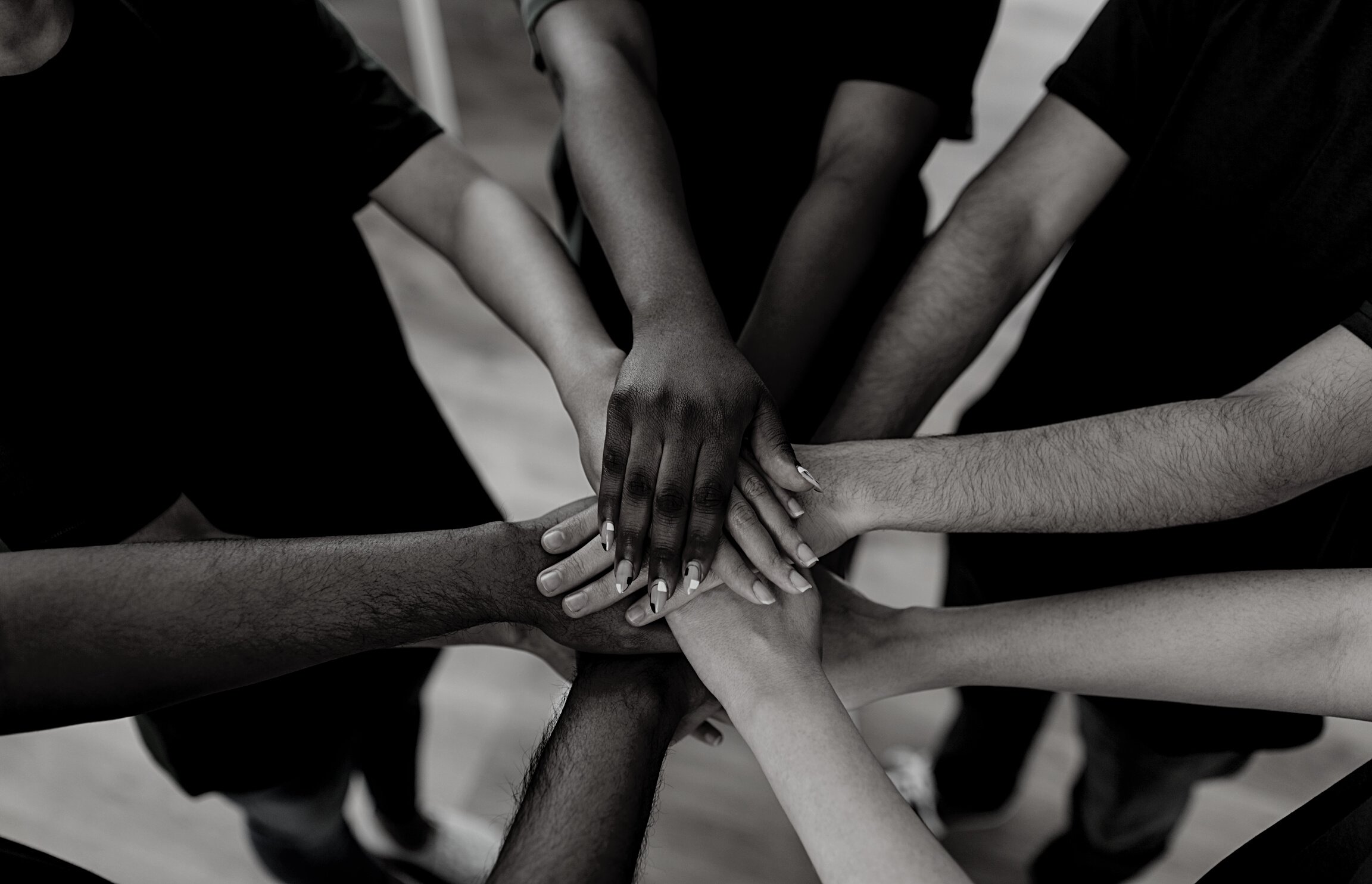 Close up of Volunteers Stacking Hands